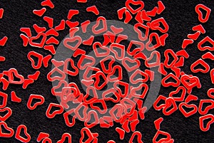 Red heart confetti on black