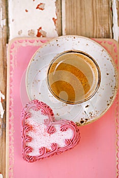 Red heart cookies and espresso Coffee cup on old wooden table