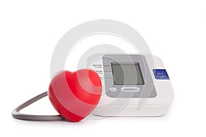 red heart in front of blood pressure meter