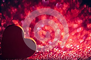 Red heart on glittery red background with copyspace
