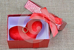 Red heart and gold ring in red box