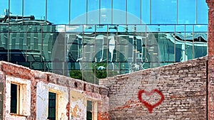 Building facade  Sun  Reflection graffiti love peace kiss red heart on wall ,modern  and old vintage house blue Windows  glass a