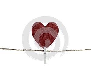 Red heart hanging on a hemp rope  on white background
