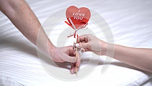 Red heart i love you in hand of man and Woman. Valentine's Day background.