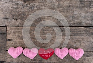 Red heart I love You and pink hearts on the wooden table