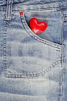 Red heart in jeans trousers pocket