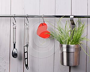 Red heart and kitchen cooking utensil on stainless