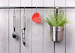 Red heart and kitchen cooking utensil on stainless