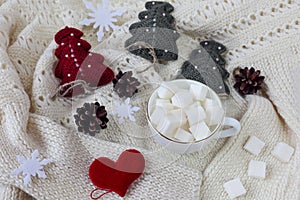 Red heart, knitted Christmas trees, a Cup of sugar on a knitted jacket , side view - the concept of waiting for heartfelt sweet