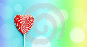 Red heart lollipop on rainbow background, love and Valentine day banner