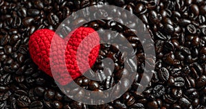 Red heart on a lot of roasted coffee beans background. Strong black espresso, Grains of coffee background, texture