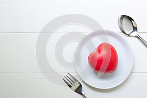 Red Heart with love and dish and spoon and fork on wooden background