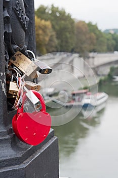 Red heart love padlock on bridge, Europe.