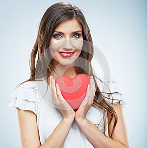 Red heart. Love symbol. Portrait of beautiful woman hold Valent