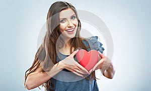 Red heart. Love symbol. Portrait of beautiful woman hold Valent