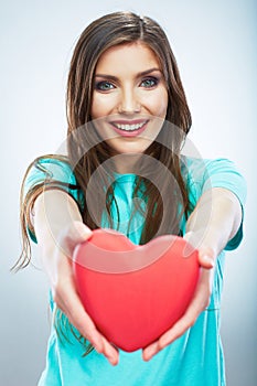 Red heart. Love symbol. Portrait of beautiful woman hold Valent