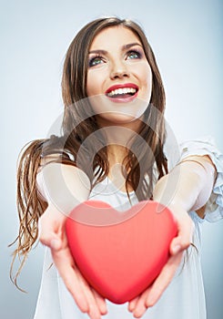 Red heart. Love symbol. Portrait of beautiful woman hold Valent