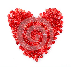 Red heart made from seeds of pomegranate,grenadine on white