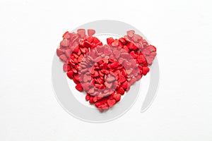 Red heart made of sweets on white background, top view