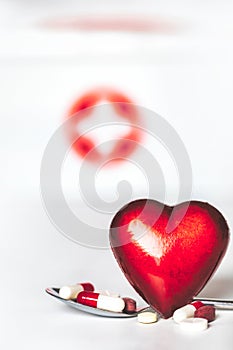 Red heart with medication pills isolated on white background, concept drugs,medicine,health,medical care with copy space