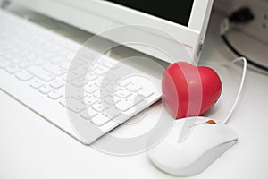 Red heart in office with computer desk set. Mini and small size of sponge heart for Muscle relaxant in hospital. Dating and