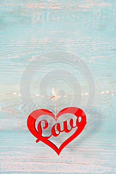 Red heart on old turquoise wooden rustic background