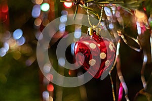 Red heart ornament in the Christmas tree