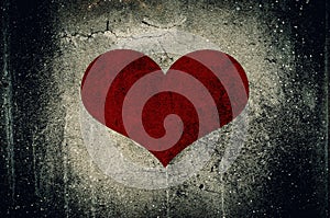 Red heart painted on grunge cement wall background