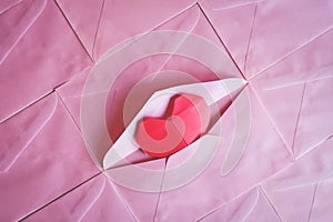 Red heart paper origami in pink envelope background