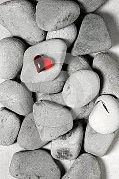 Red heart on pebble stones, still life. Valentines day and lovers background