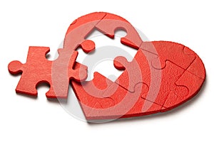 Red heart puzzle on white background. Concept second half of the heart in love for Valentine`s Day or illness