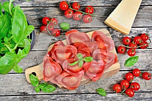 Red heart ravioli with tomato, mozzarella and basil