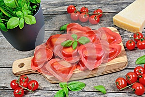 Red heart ravioli with tomato, mozzarella and basil