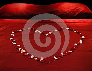 Red heart on red bed