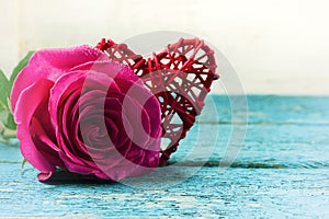 Red heart and roses on the wooden background.