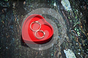 A red heart shape box with a textured background