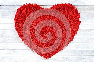 Red heart shape cleaning feet doormat or carpet texture.