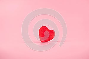 Red heart shape decoration with copy space for text on pink background. Love, Wedding, Romantic and Happy Valentine day holiday