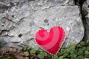 Red heart shape on a rock background