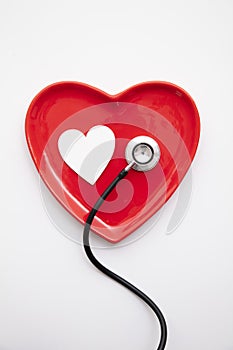 Red heart shape with a stethoscope. Healthy heart concept