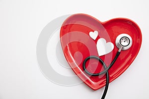 Red heart shape with a stethoscope. Healthy heart concept