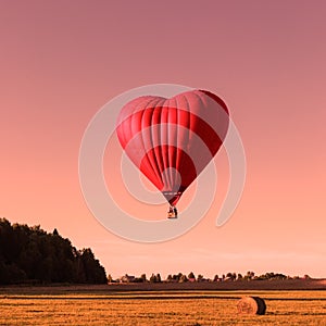 Red heart shaped air ballon, trendy color coral toned photo