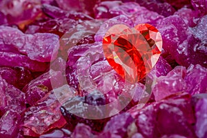 Red heart shaped diamond on natural red garnet tumbled stone.