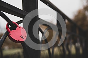 Red heart shaped keylock on a fence