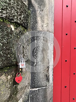 Red heart shaped padlock and red door