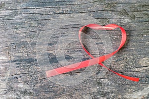 Red heart shaped ribbon awareness for World aids day campaign supporting people with HIV, STD disease