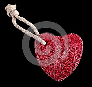 Red heart-shaped stone with rope