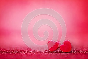 Red Heart shapes on abstract light glitter background in love co