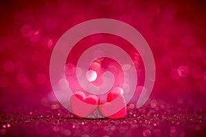 Red Heart shapes on abstract light glitter background in love co