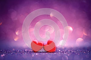 red Heart shapes on abstract light glitter background in love co